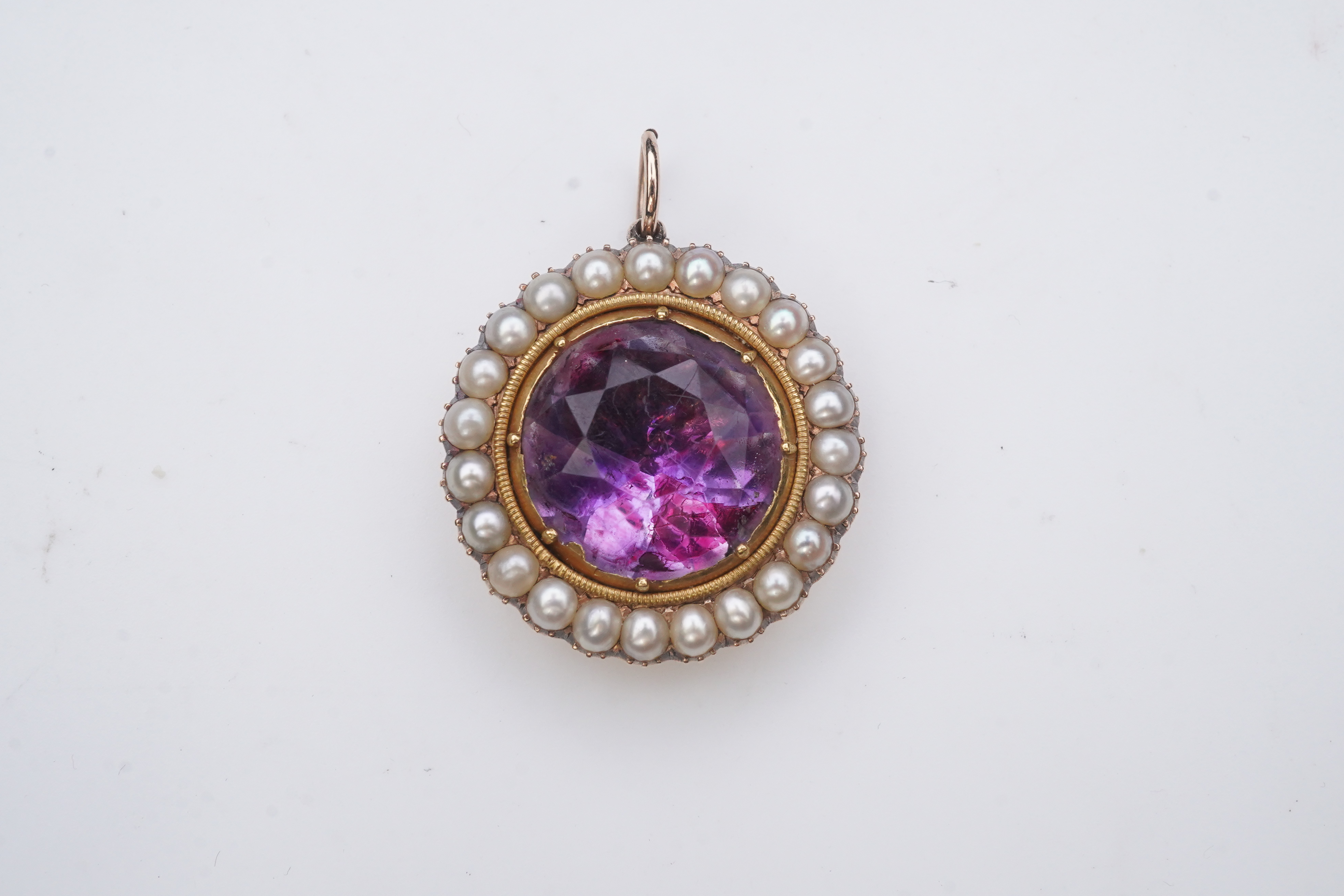 A Victorian amethyst and half pearl pendant, mid 19th century